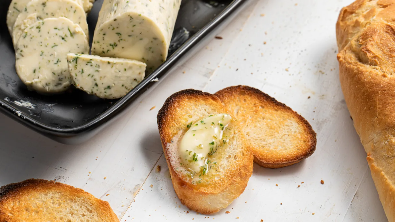Homemade herb butter on baked bread